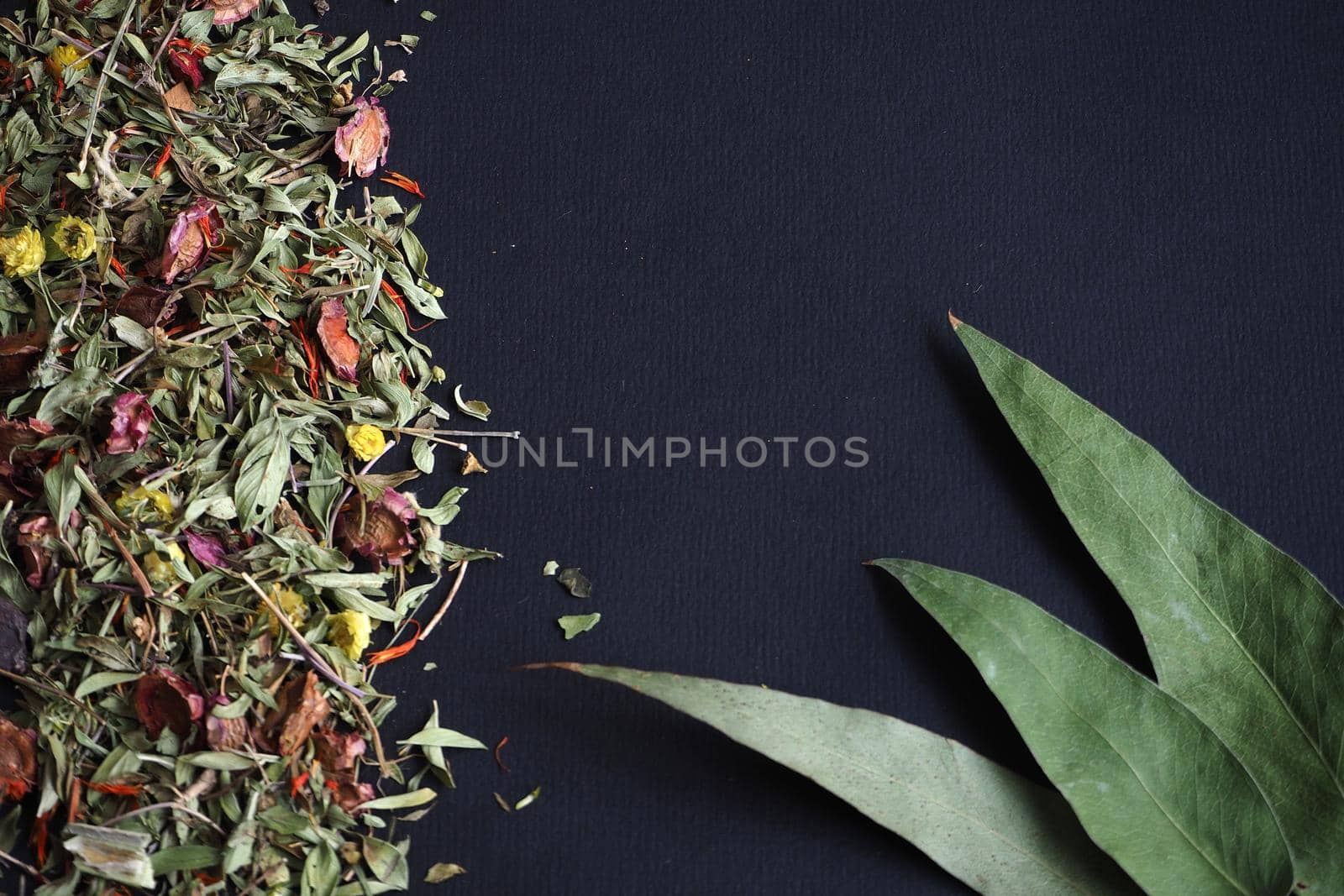 Ingredients for herbal tea on a black background. by Olga26