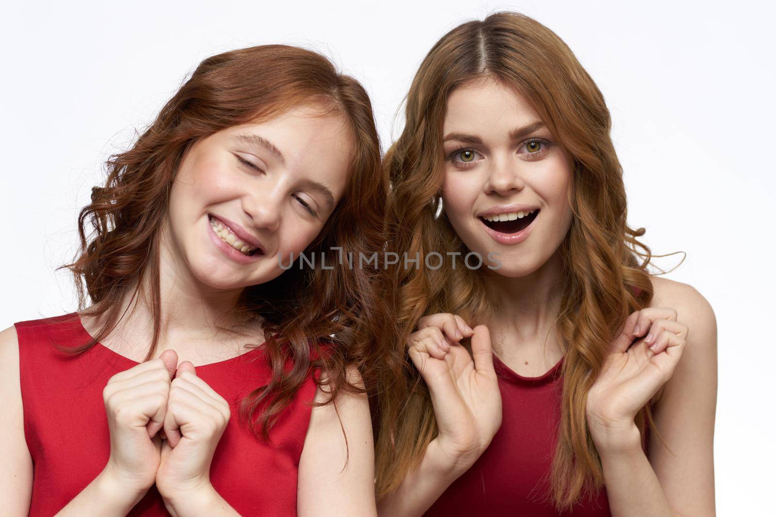 Cheerful mom and daughter hugs joy lifestyle family light background. High quality photo