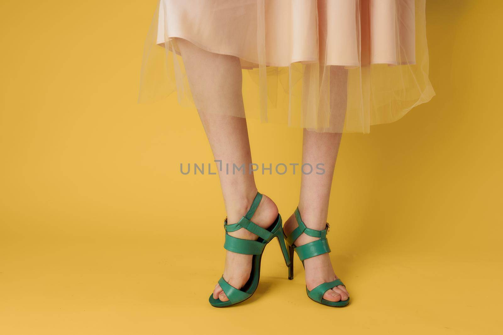 Fashionable shoes green shoes female feet shopping yellow background by SHOTPRIME
