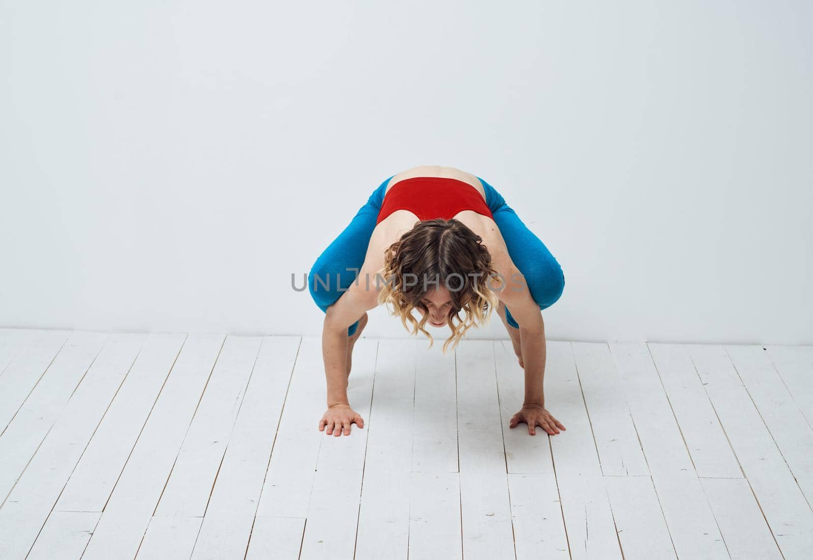 Sportive woman doing exercises on the floor yoga asana meditation by SHOTPRIME