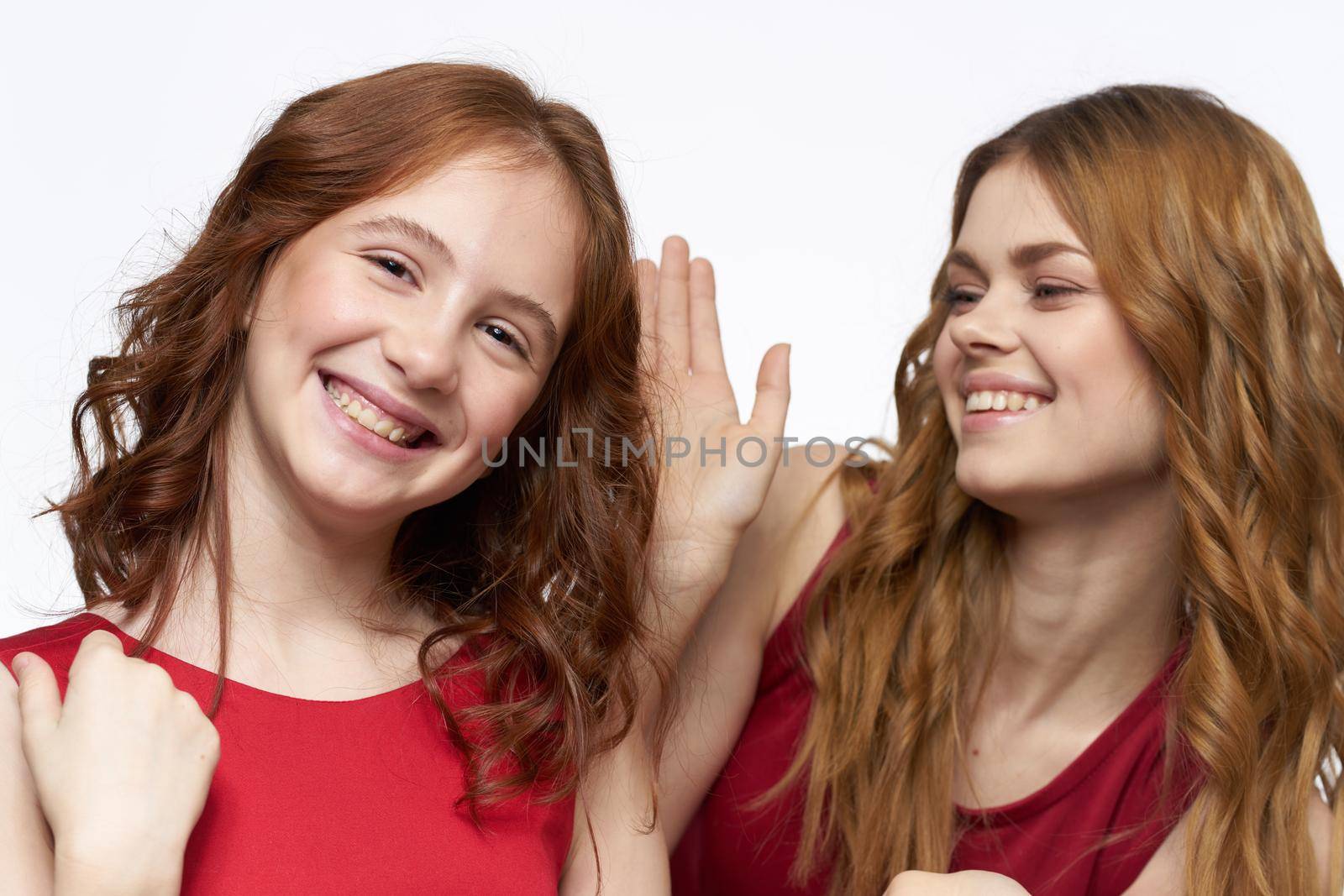 Cheerful mom and daughter hugs joy lifestyle family light background. High quality photo