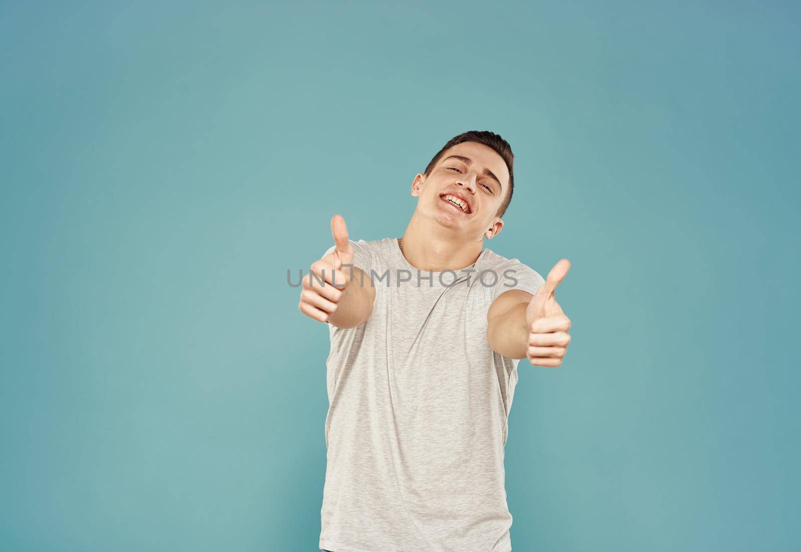 handsome man t shirt emotions hand gestures blue background. High quality photo