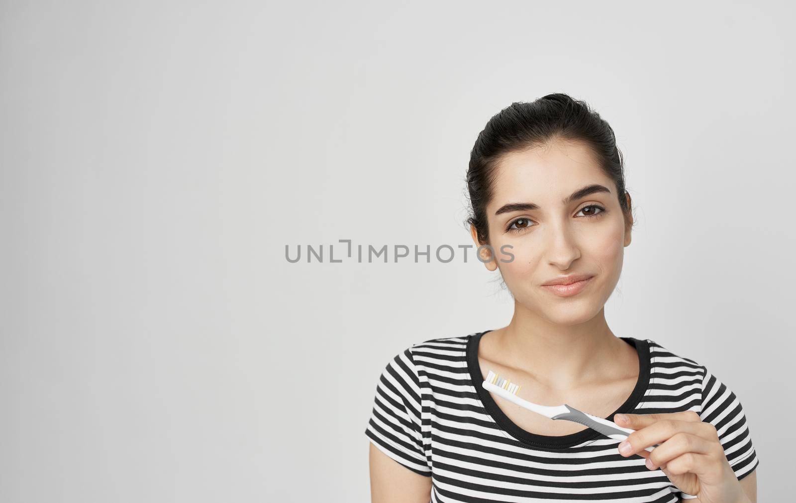 woman in striped t-shirt toothbrush dental health hygiene by SHOTPRIME
