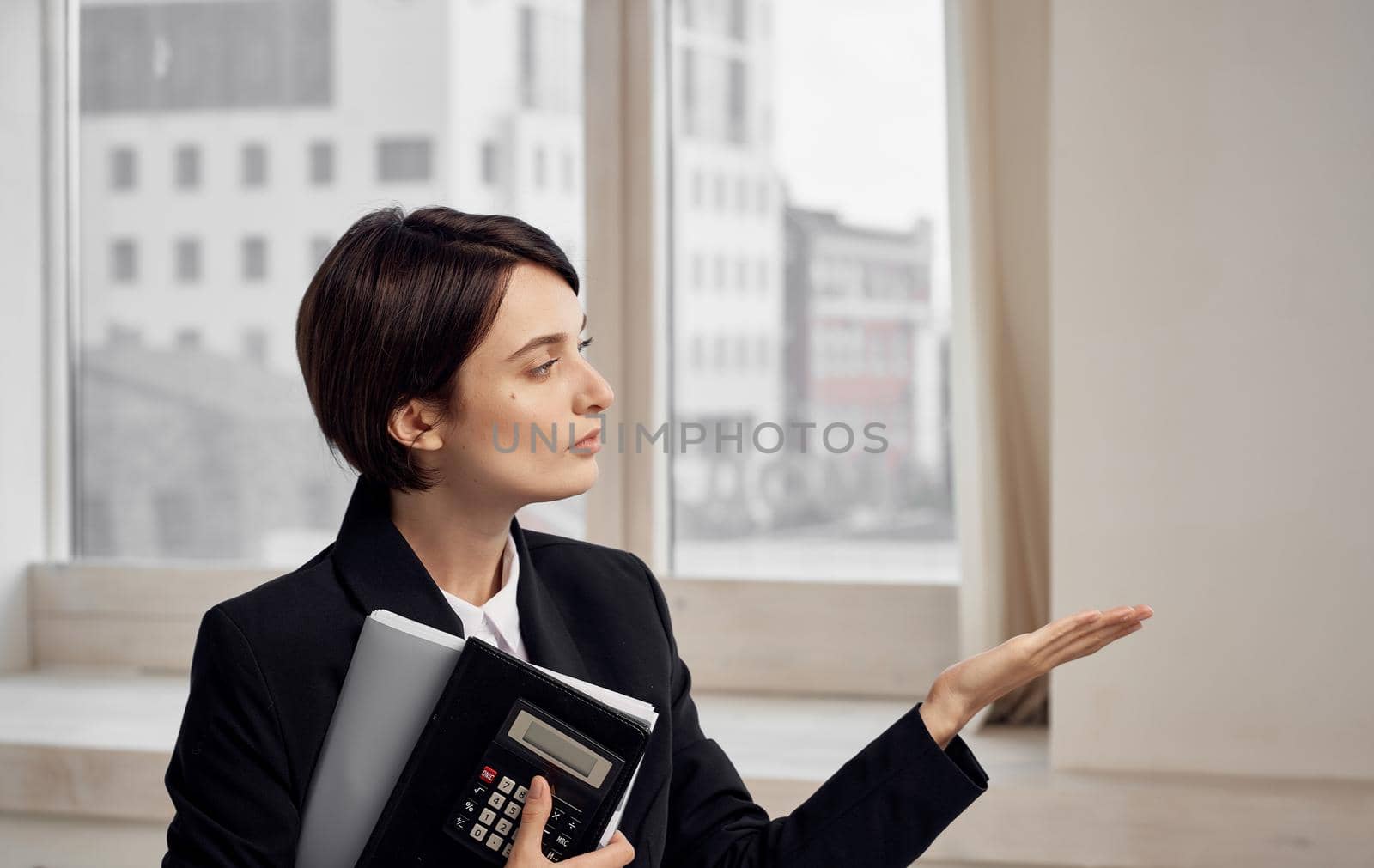 finance model woman in black jacket with documents in hands. High quality photo