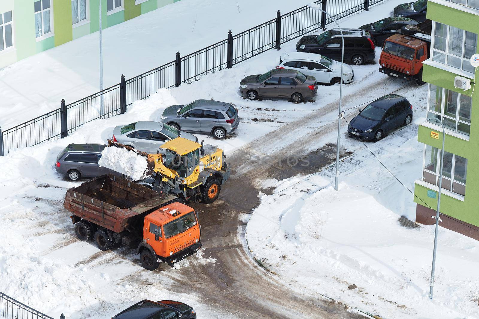 Nizhny Novgorod, Russia, Gagarin Avenue 101 Corpus 1, 2021.03.02.Snow removal in the yard of an apartment building by special snowplows. by Olga26