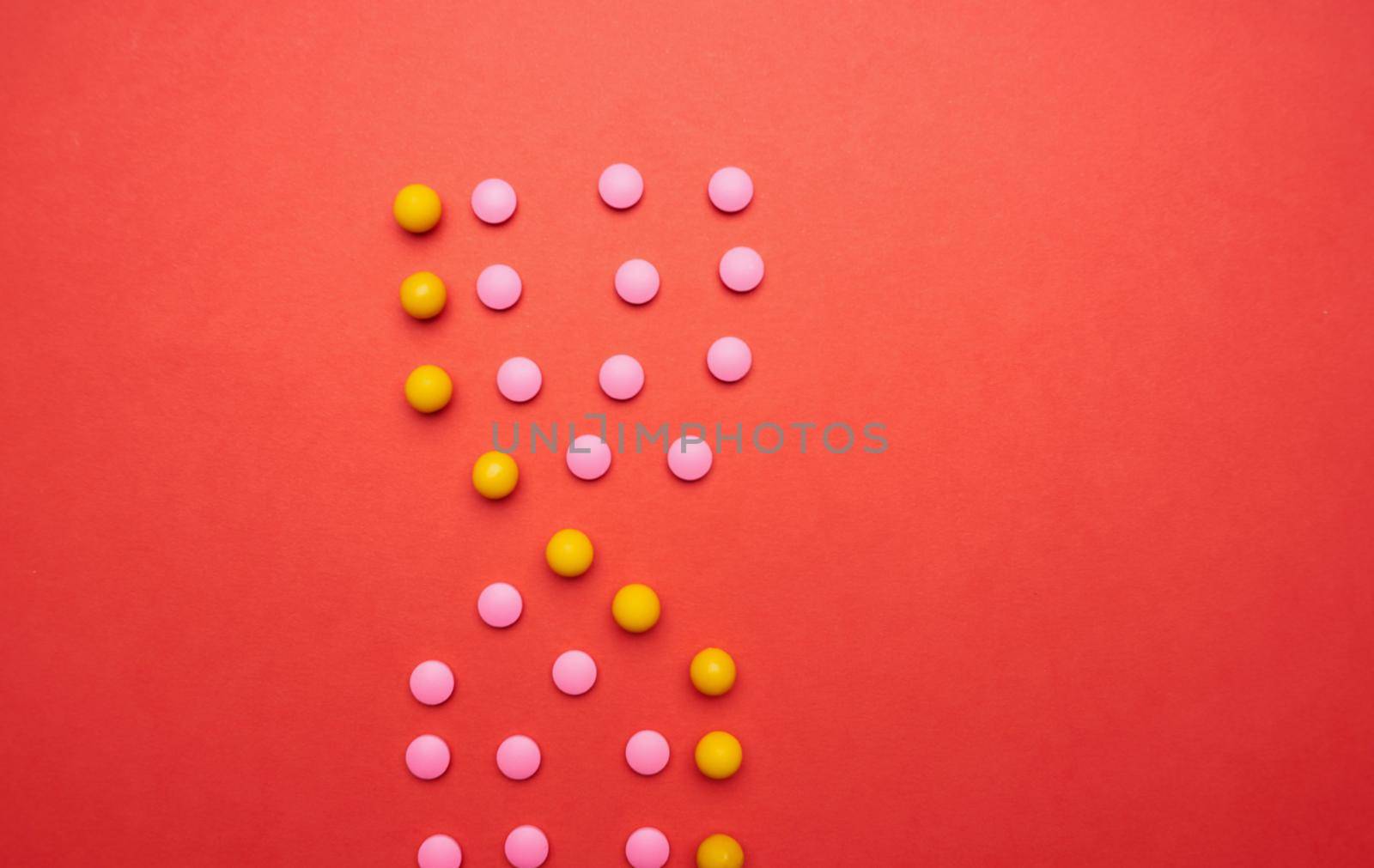 multicolored pills on red background medicine health by SHOTPRIME