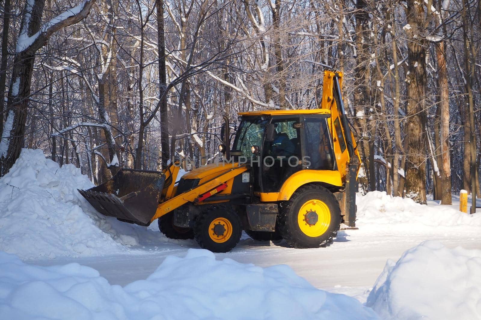 Snow removal with special equipment. Winter, lots of snow. Special equipment for cleaning snow from the street. by Olga26