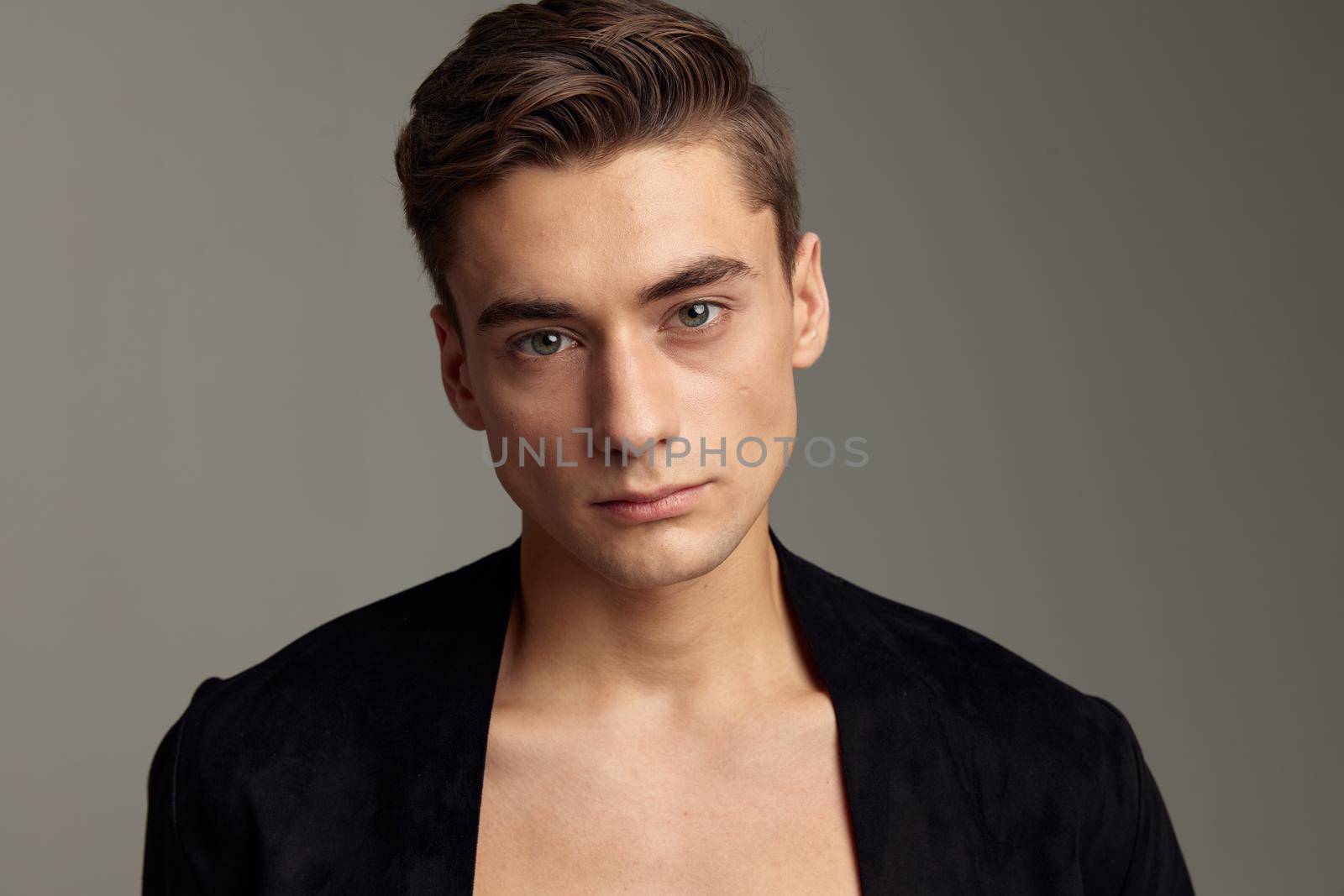 Handsome man fashionable hairstyle black jacket close-up. High quality photo