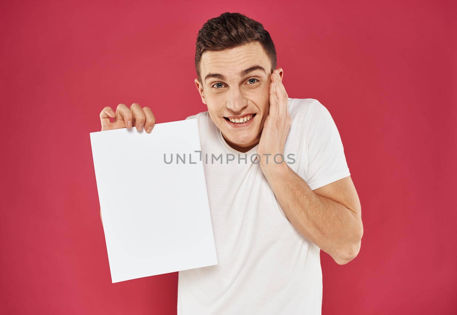 Joyful man on a red background with a white flag in his hand mock up poster. High quality photo