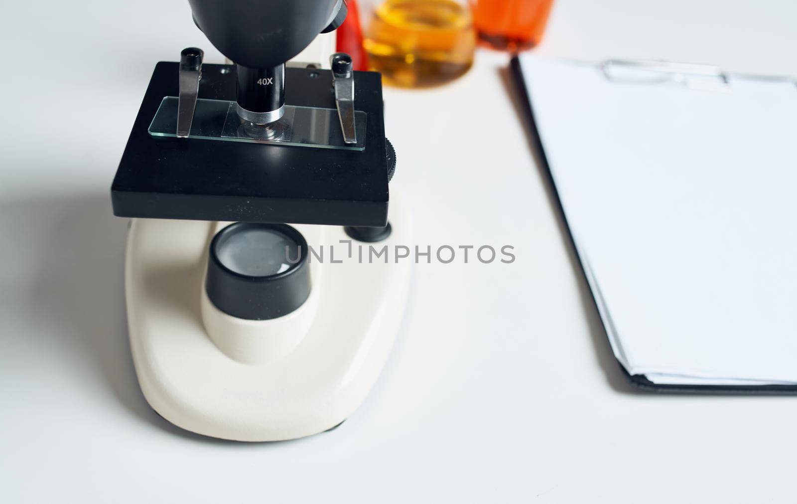 microscope laboratory chemical element magnifying glass papers on table by SHOTPRIME