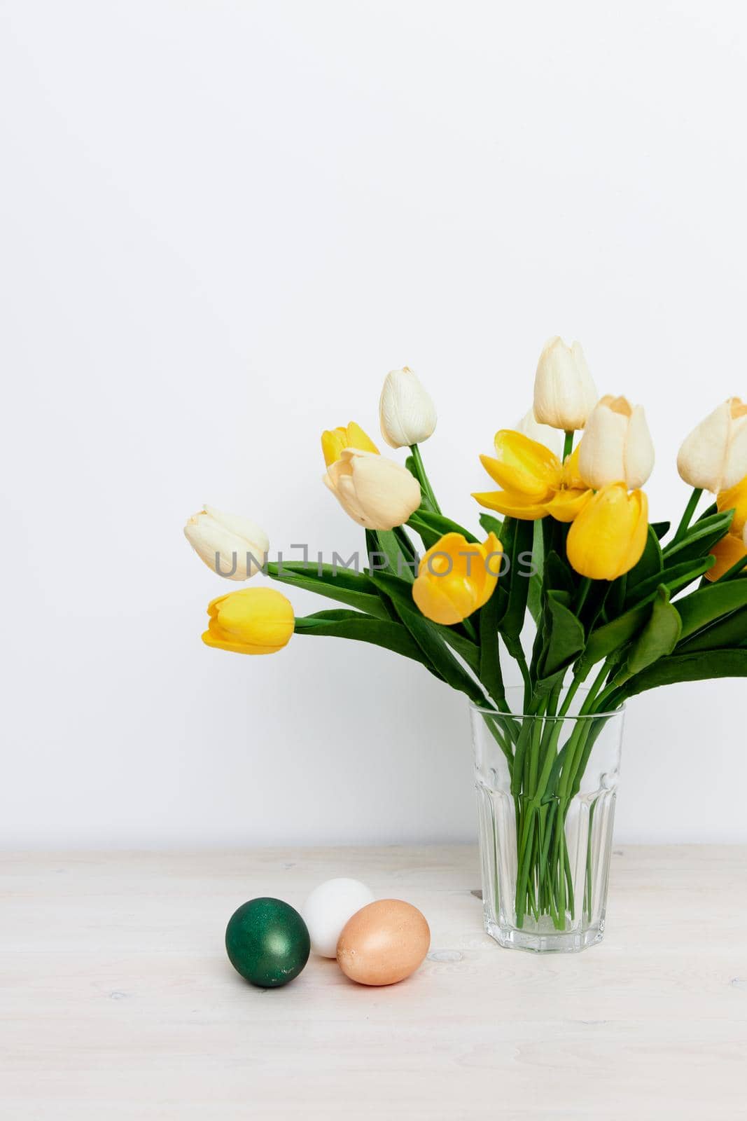 Easter holiday church traditions colorful eggs and yellow tulips by SHOTPRIME