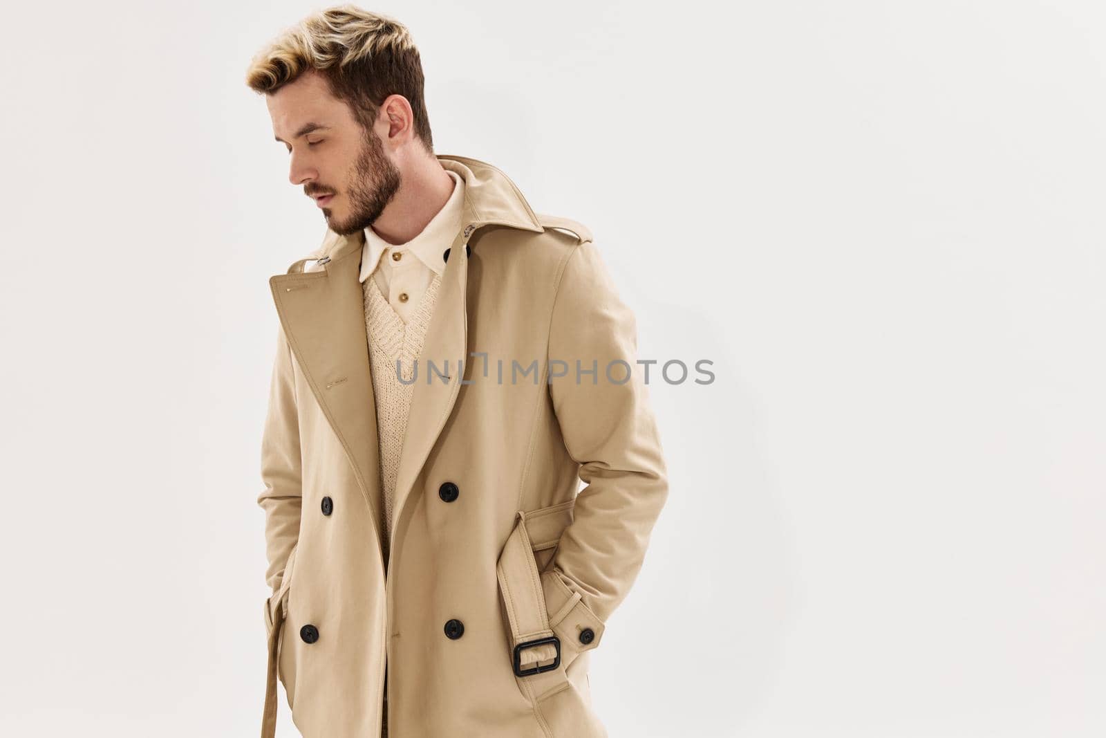 man in coat hands in pocket side view hairstyle modern style. High quality photo