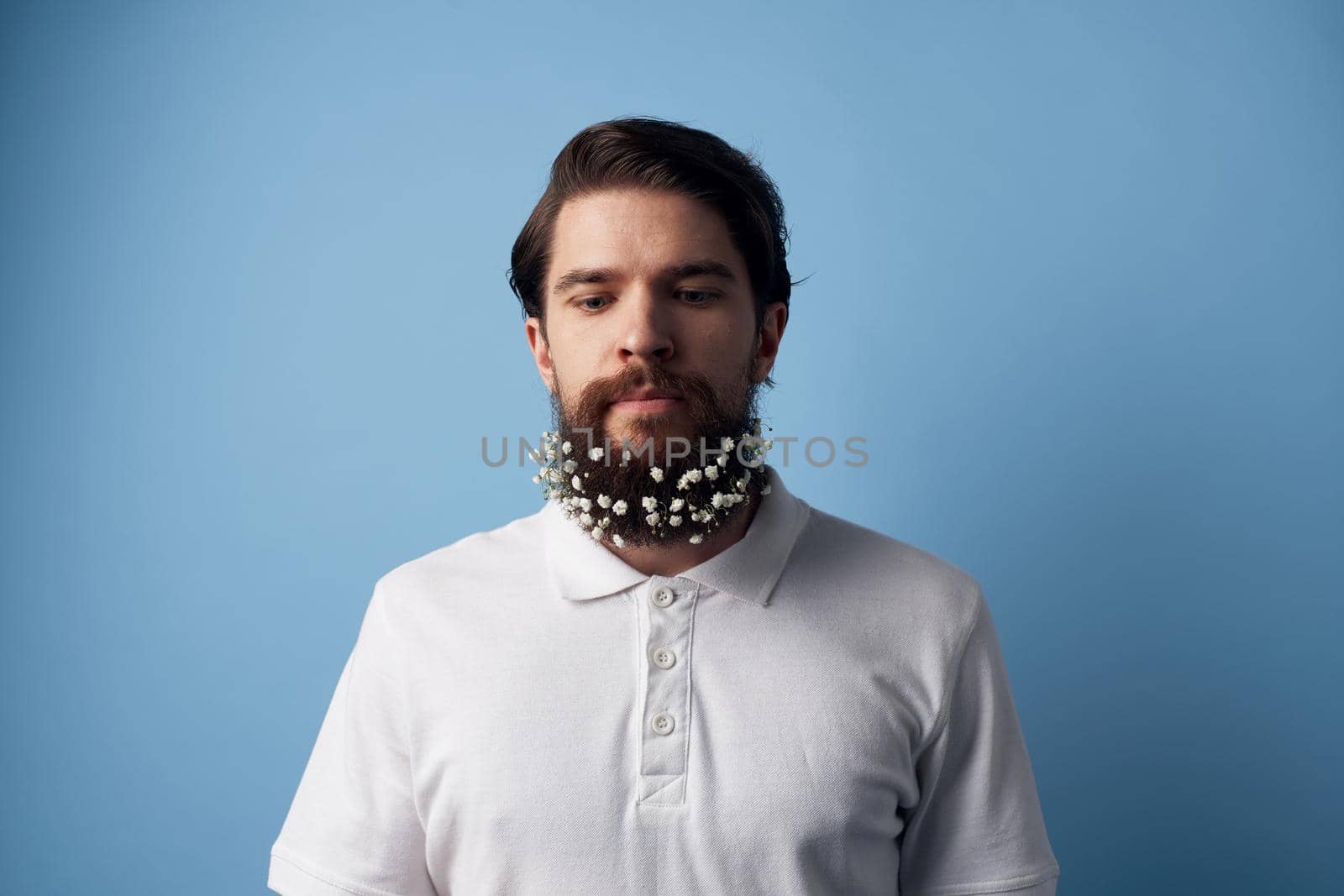 Cute man and white T-shirt flowers on beard decoration. High quality photo