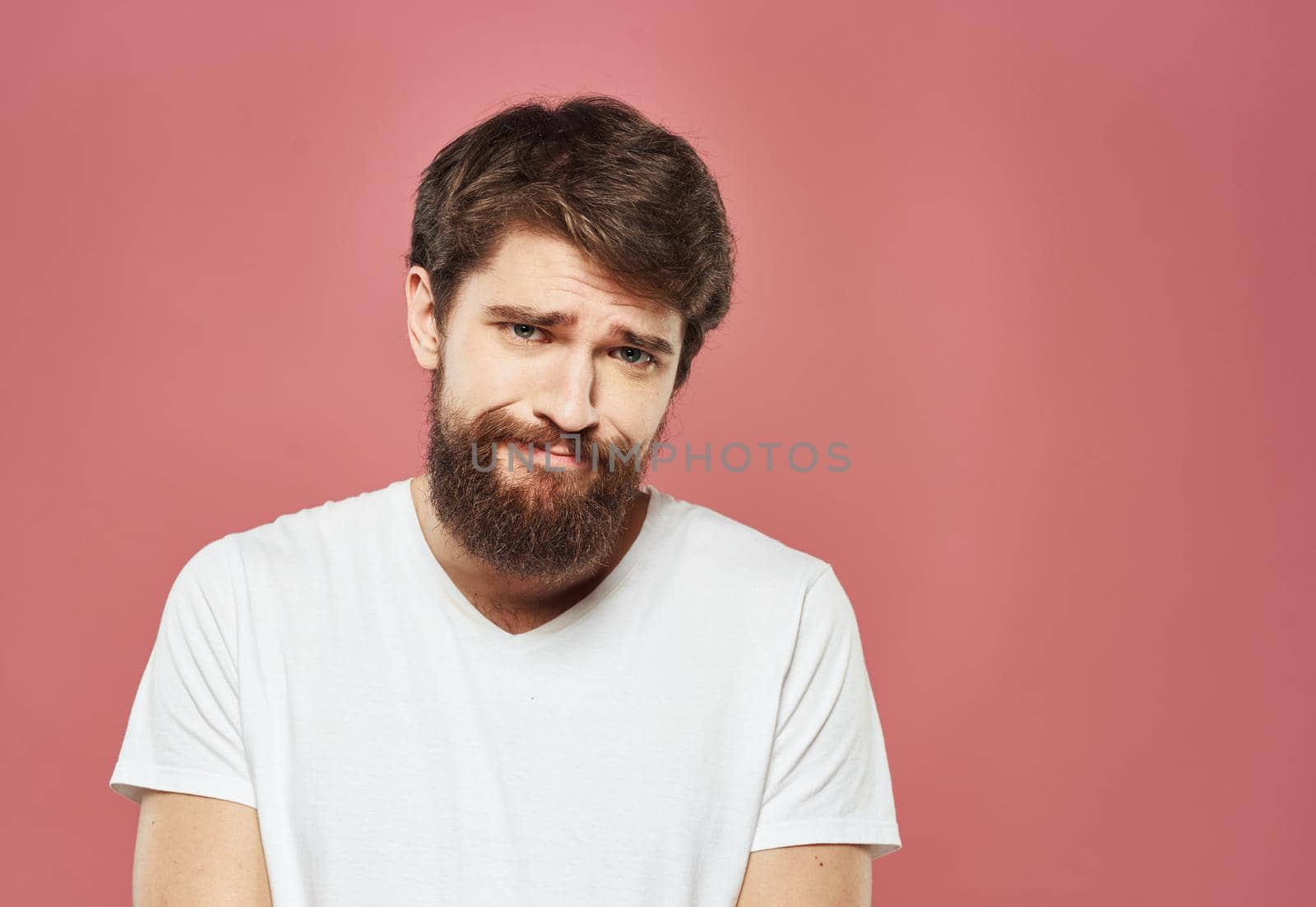 man grimacing on pink background cropped view Copy Space by SHOTPRIME