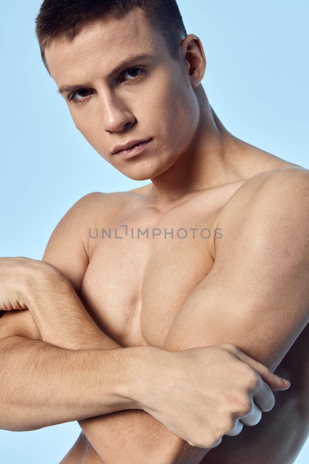 man with folded arms pumped up muscular torso workout close-up by SHOTPRIME