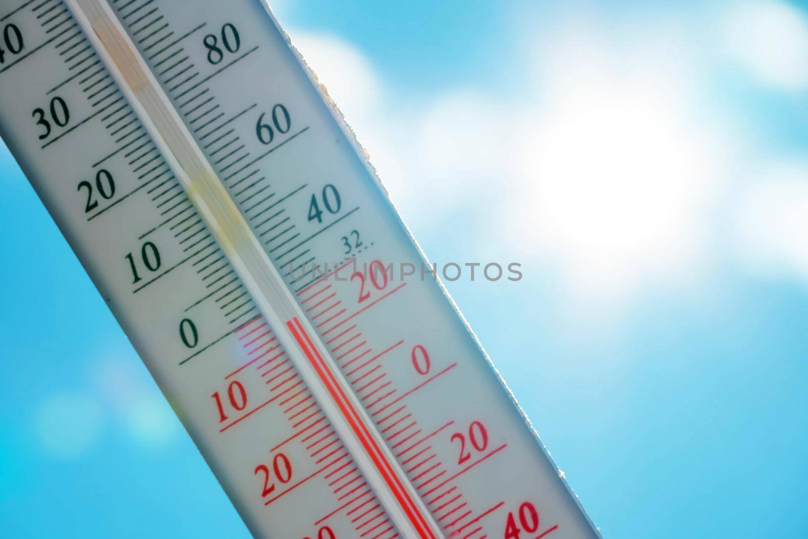 The thermometer lies on the snow in winter showing a negative temperature.Meteorological conditions in a harsh climate in winter with low air and ambient temperatures.Freeze in wintertime.Sunny winter