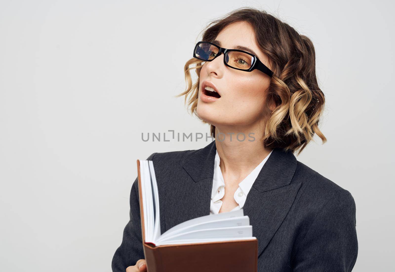 Business woman in classic suit brown book cropped view. High quality photo