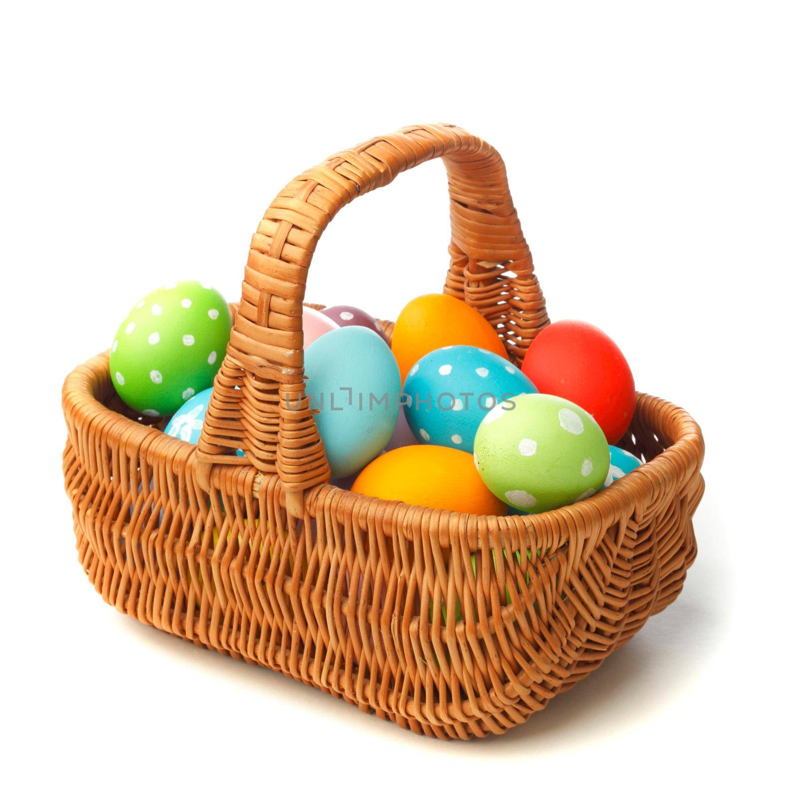 Basket with color Easter eggs isolated on white background