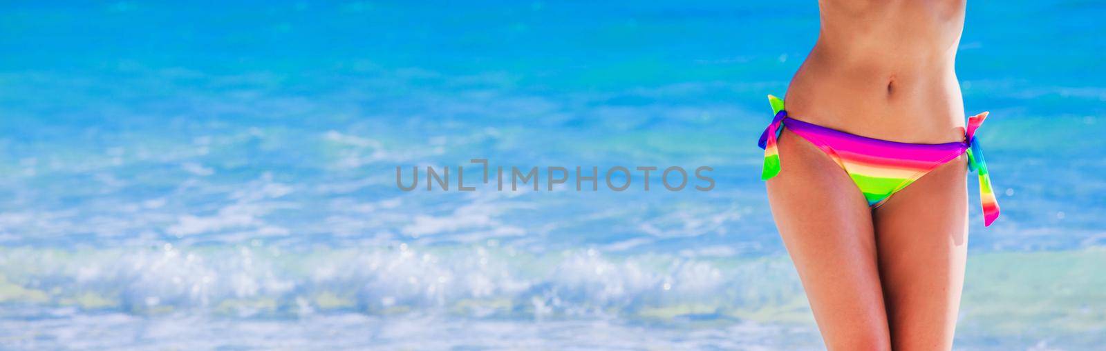 Woman with perfect body in bikini over tropical sea background