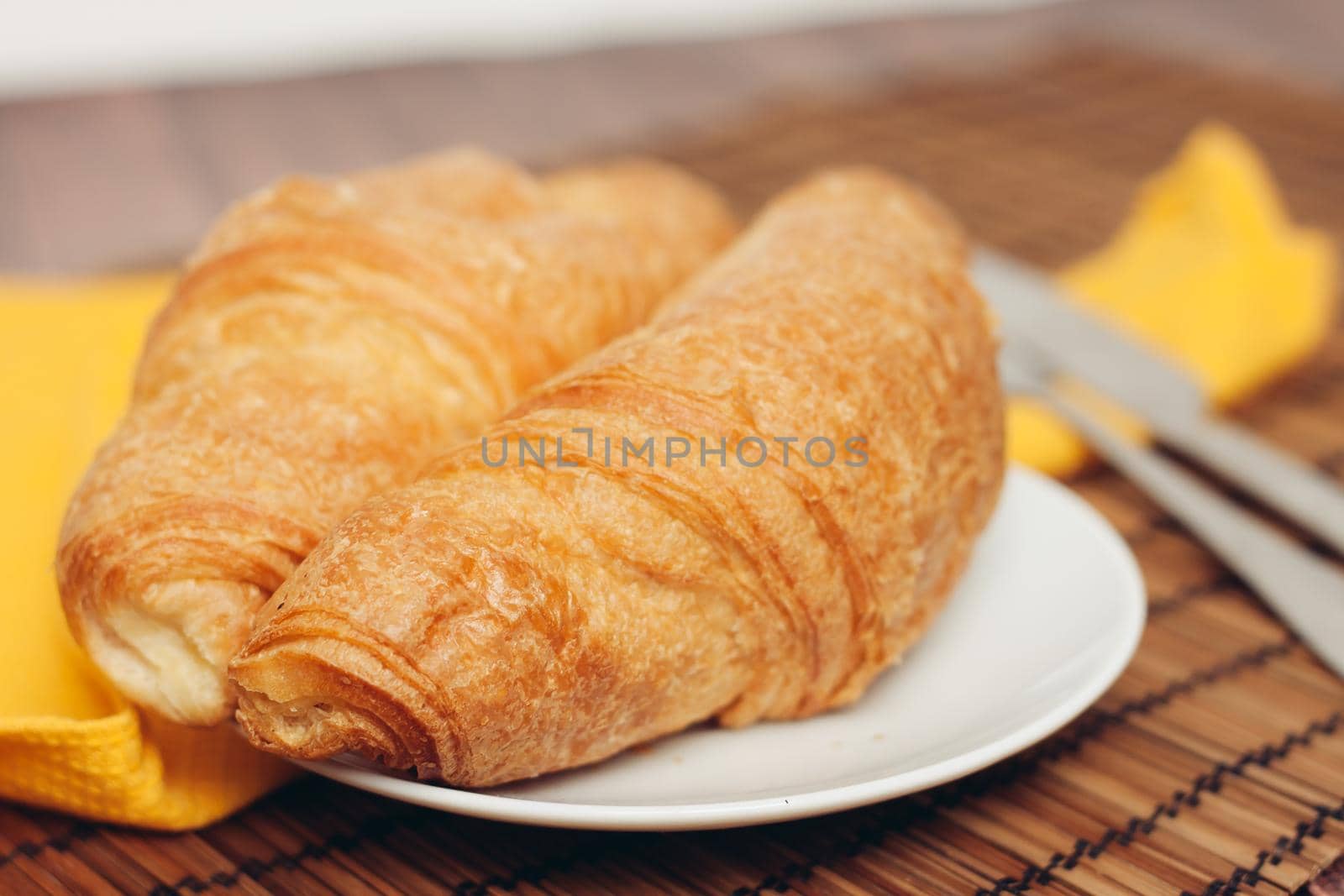 croissants saucer on the table fork with a knife fresh pastries dessert morning by SHOTPRIME