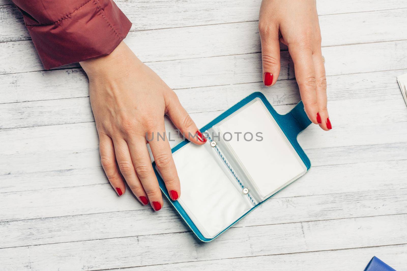 blue business card wallet and wooden table female lessons bright nails by SHOTPRIME