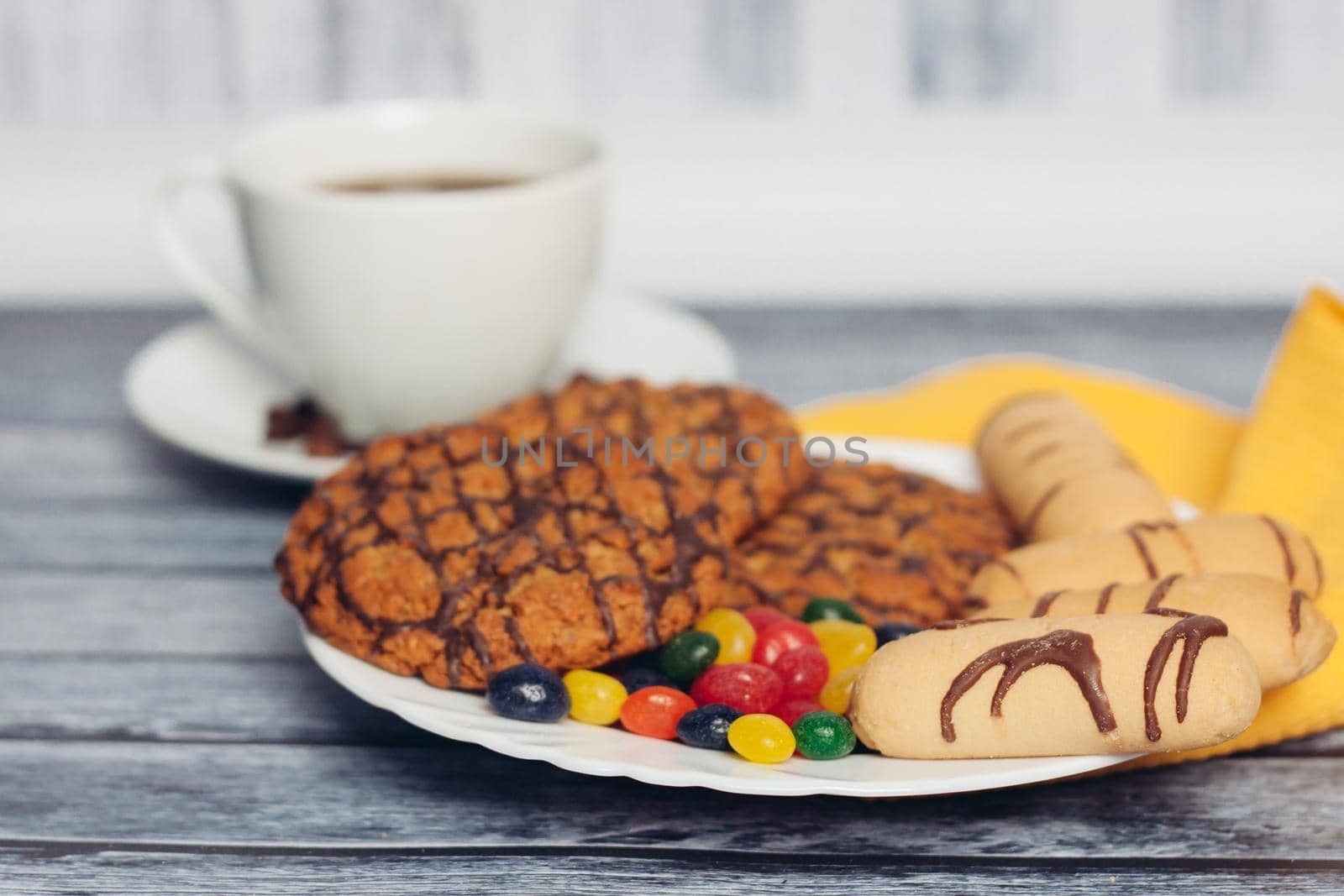 cookies on a plate a cup of tea on a wooden table by SHOTPRIME
