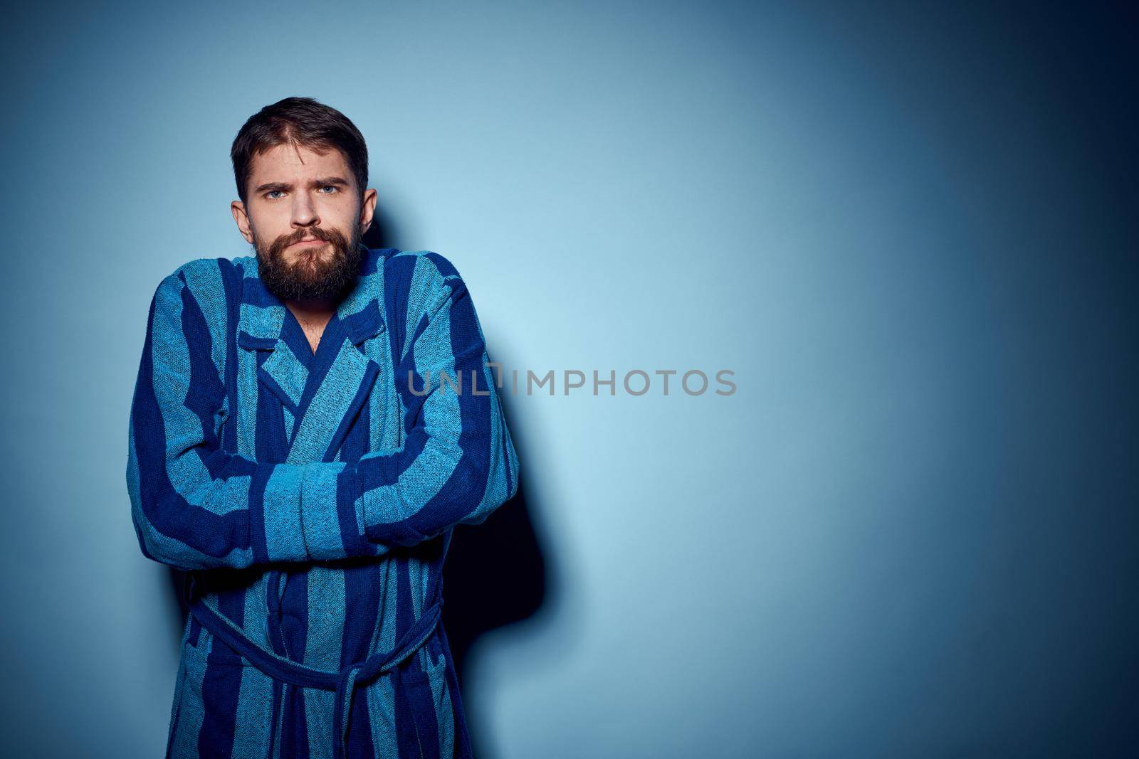 man in blue robe emotions lifestyle morning studio. High quality photo