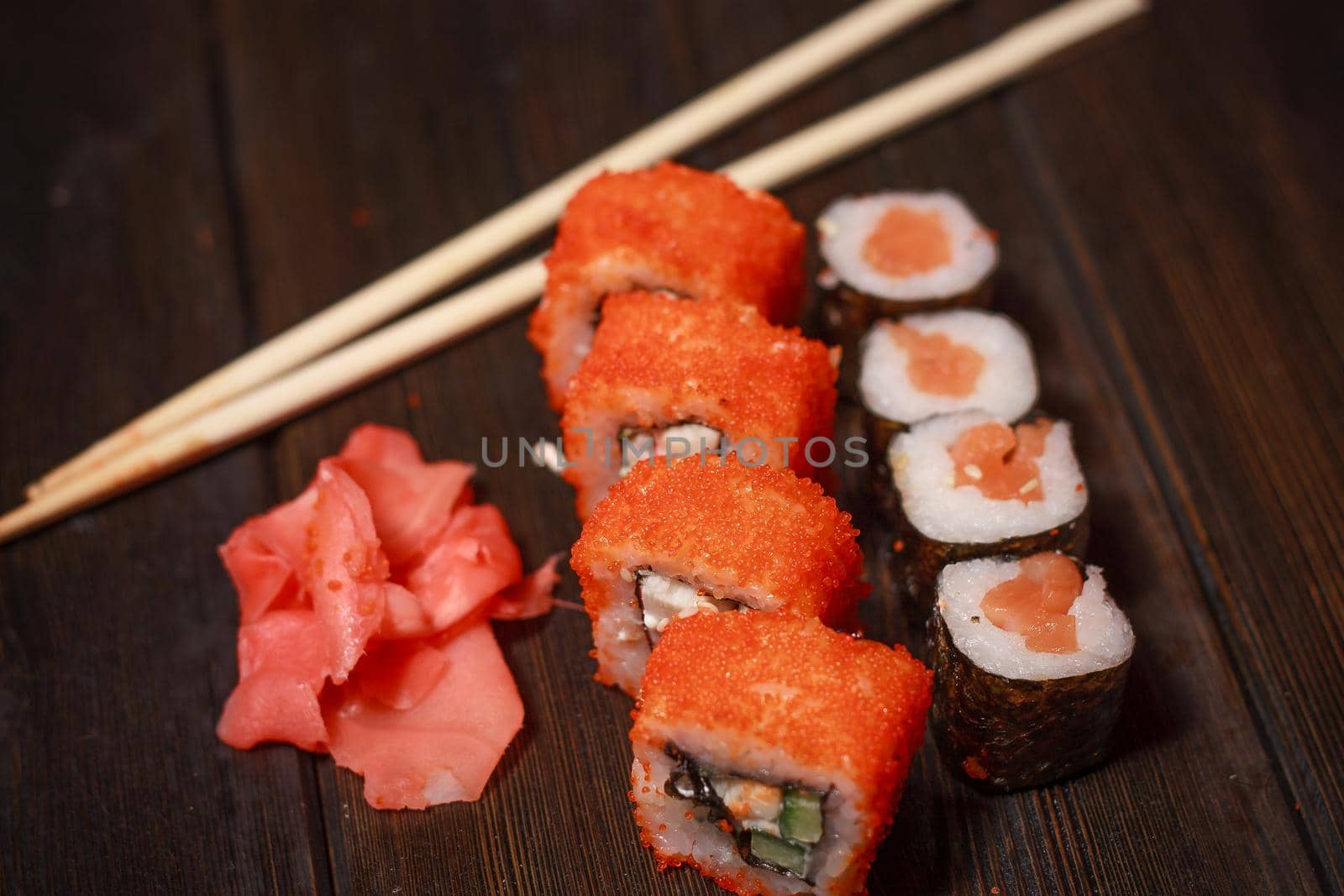 asian cuisine sushi and rolls on the table wooden sticks ginger wasabi. High quality photo