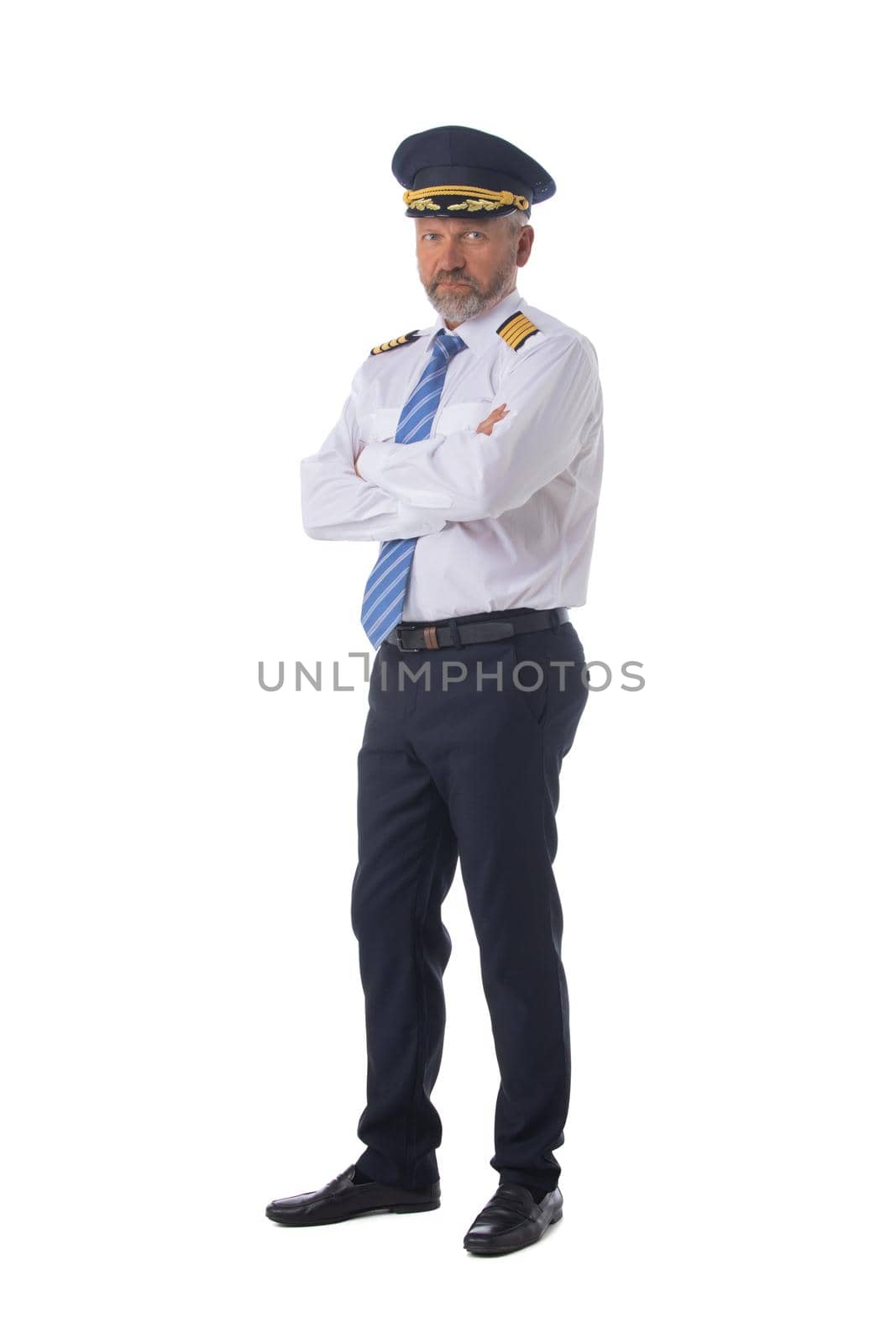 Airline first pilot, aircraft commander, standing with arms folded isolated on white background, full length portrait