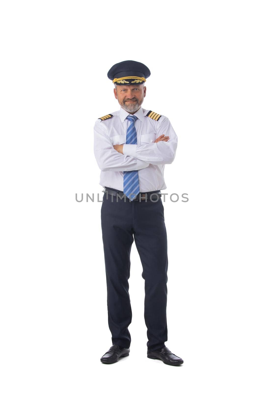 Airline first pilot, aircraft commander, standing with arms folded isolated on white background, full length portrait