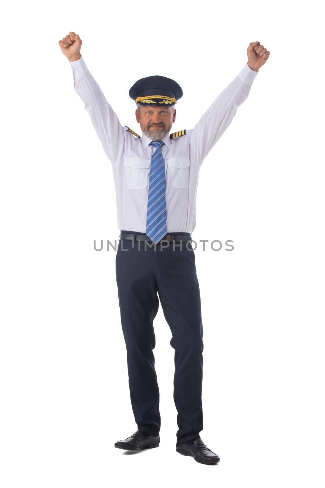 Airline pilot wearing the four bar Captains epaulettes, first pilot, aircraft commander with raised arms isolated on white background full length studio portrait