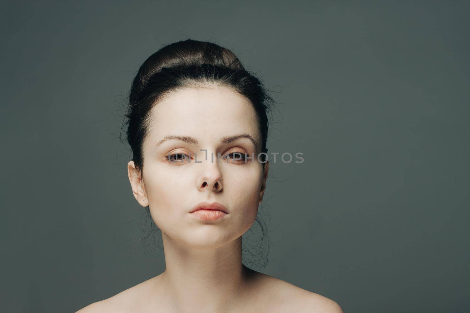 portrait of a beautiful brunette woman with bare shoulders fashionable hairstyle model by SHOTPRIME