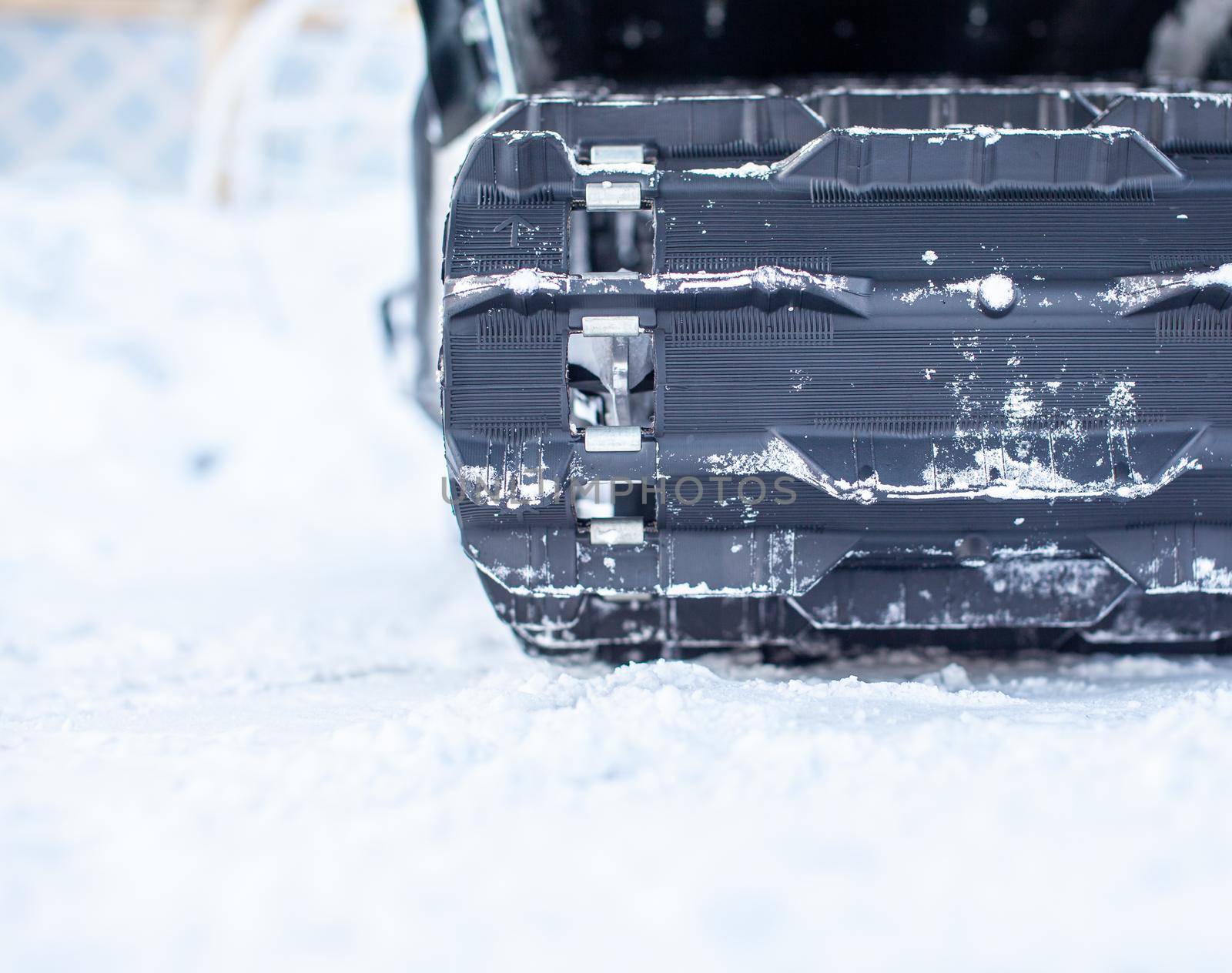 The back of a snowmobile in winter and riding in the snow on a snowmobile.