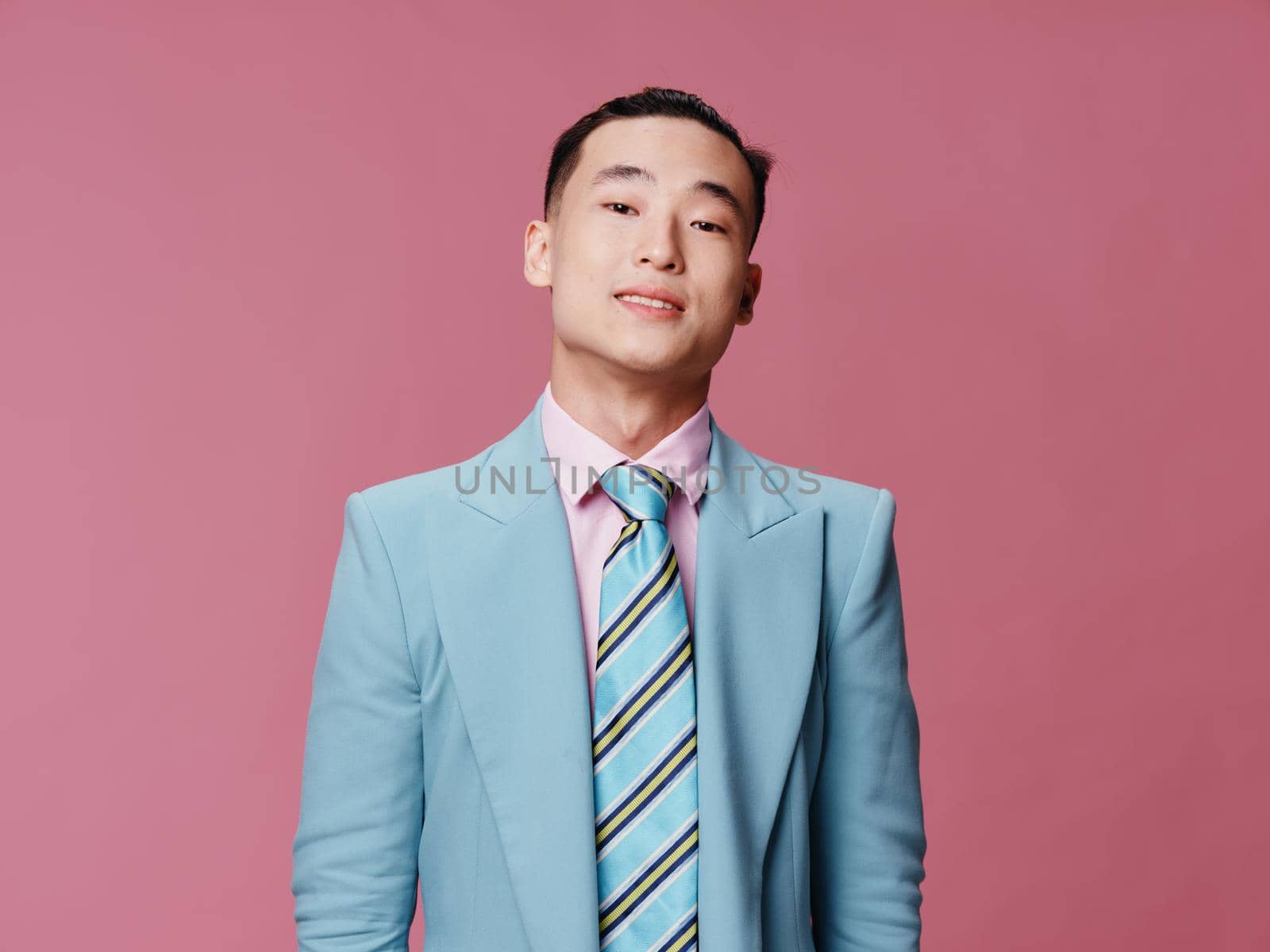 Cute elegant man of Asian appearance blue jacket striped tie . High quality photo
