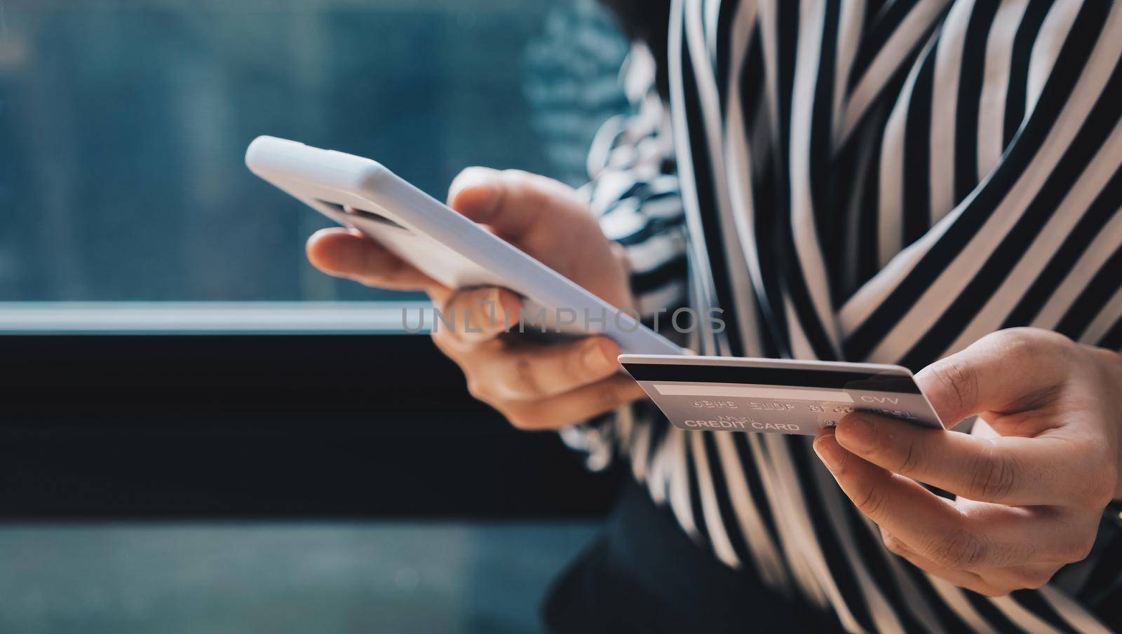 Online payment,Woman's hands holding a credit card and using smart phone for online shopping