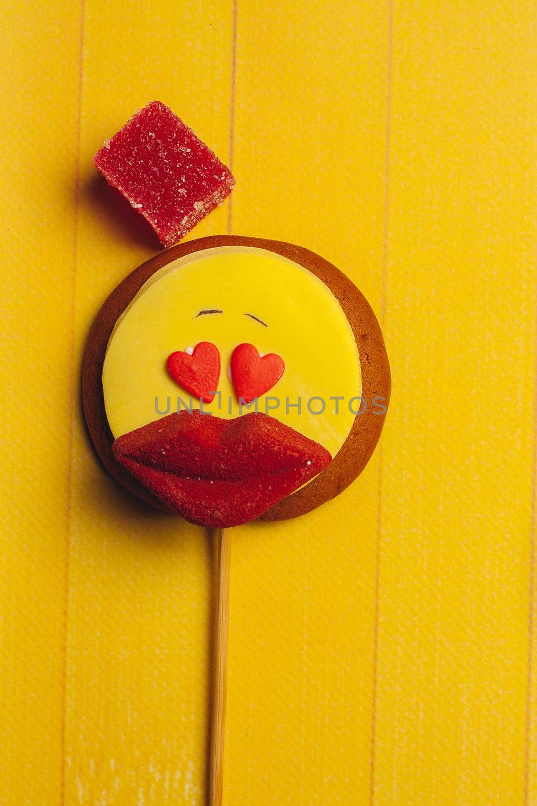 gingerbread in the form of a smiley red lips marmalade dessert sweets yellow background by SHOTPRIME