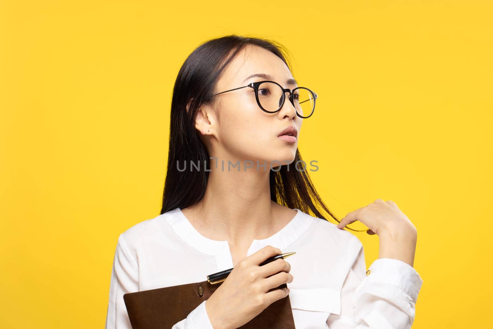 woman of asian appearance white shirt notepad in hands work manager. High quality photo