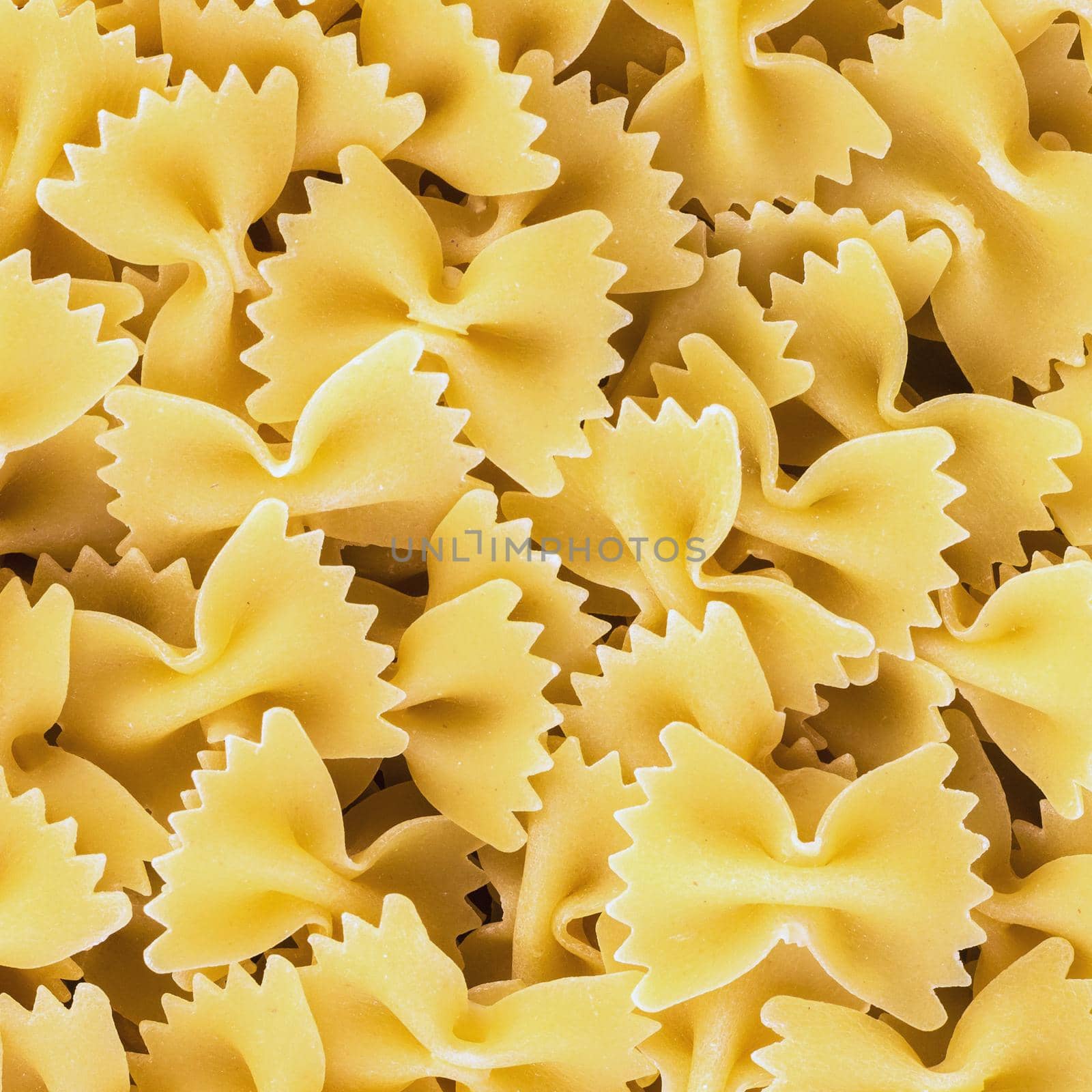 Traditional italian farfalle pasta. Famous variety of type and shape of Italian pasta. Dry pasta bows "farfalle".