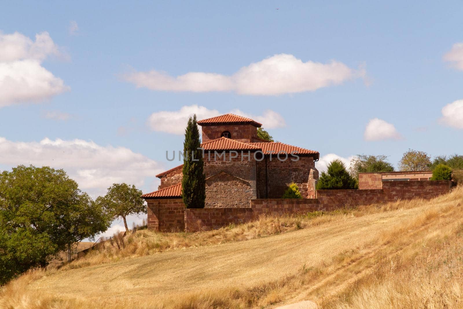 A small church on the top of a hill on a sunny day