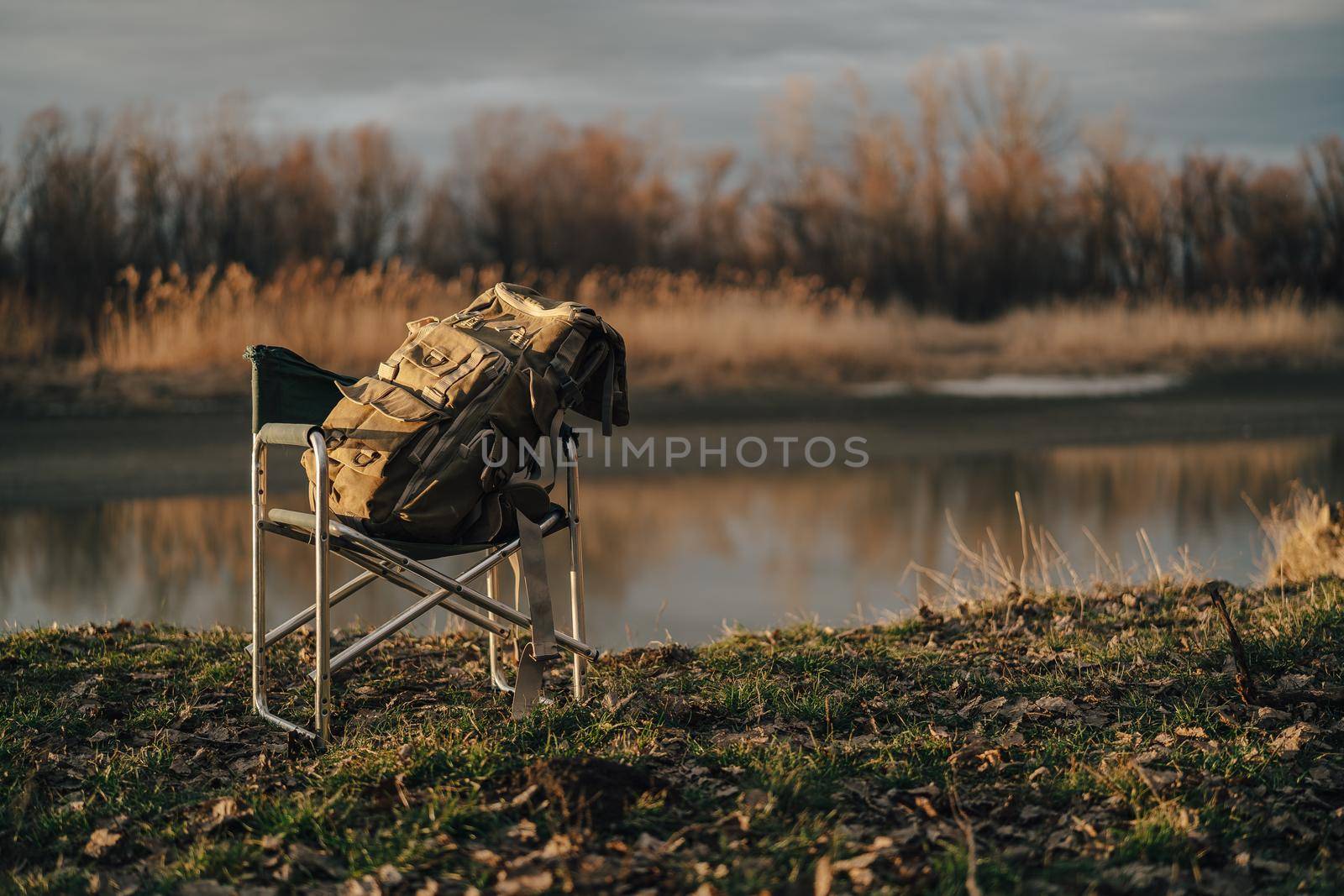 big tourist bag on folding chair travel fishing lake nature. High quality photo