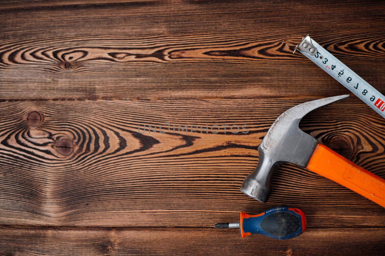 centimeter tape on wooden table background image hammer top view. High quality photo