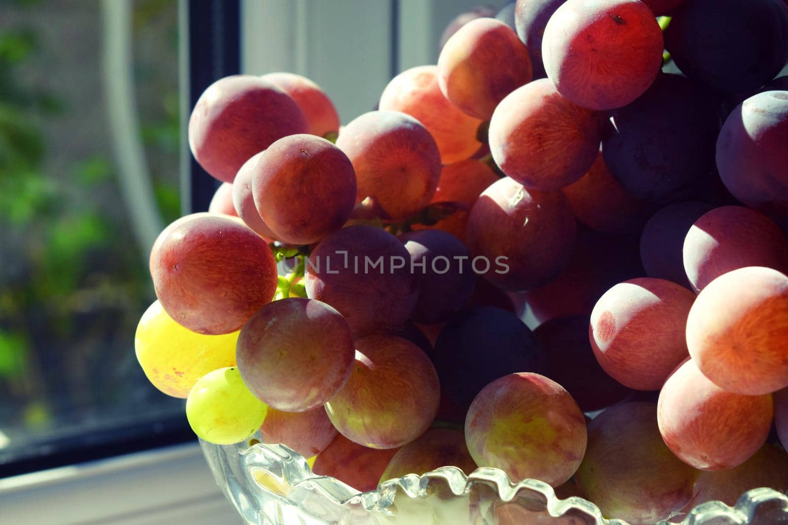 Grape in crystal vase dessert fruit on white background by IaroslavBrylov