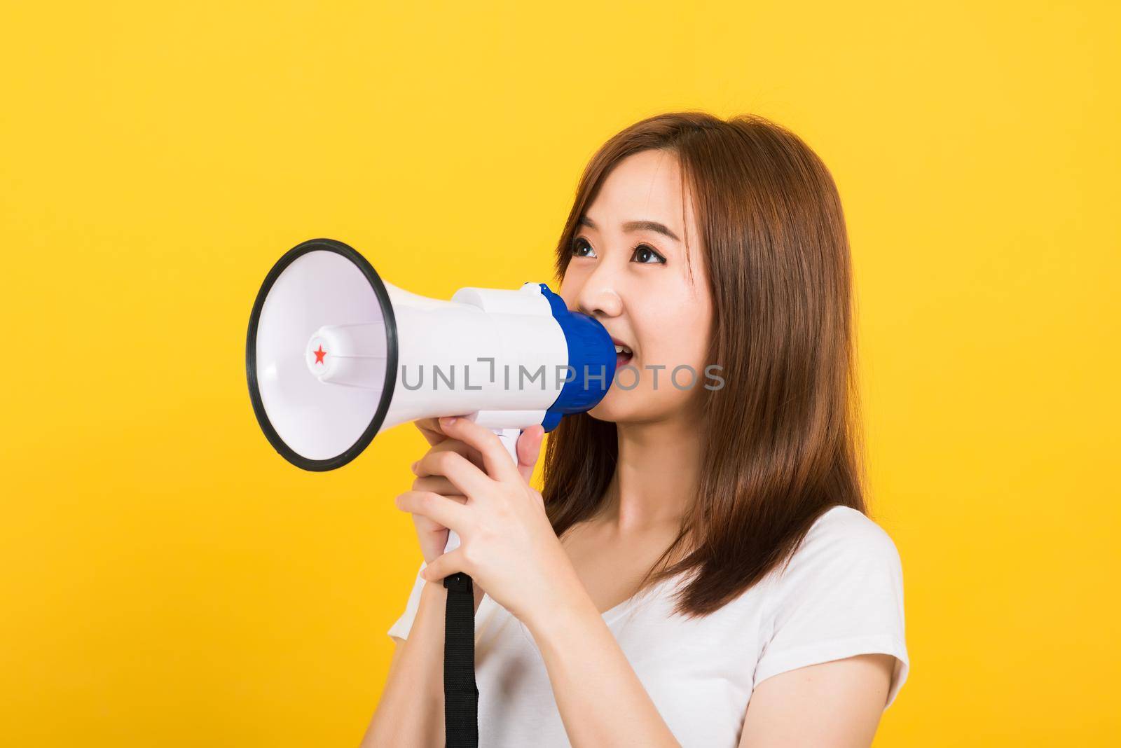 woman teen standing making announcement message shouting screaming in megaphone by Sorapop