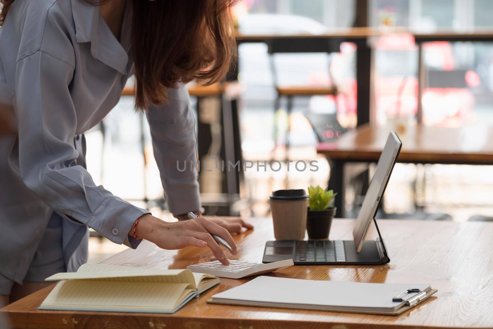 Business woman using calculator for working finance and accounting Analyze financial budget in the office. by nateemee