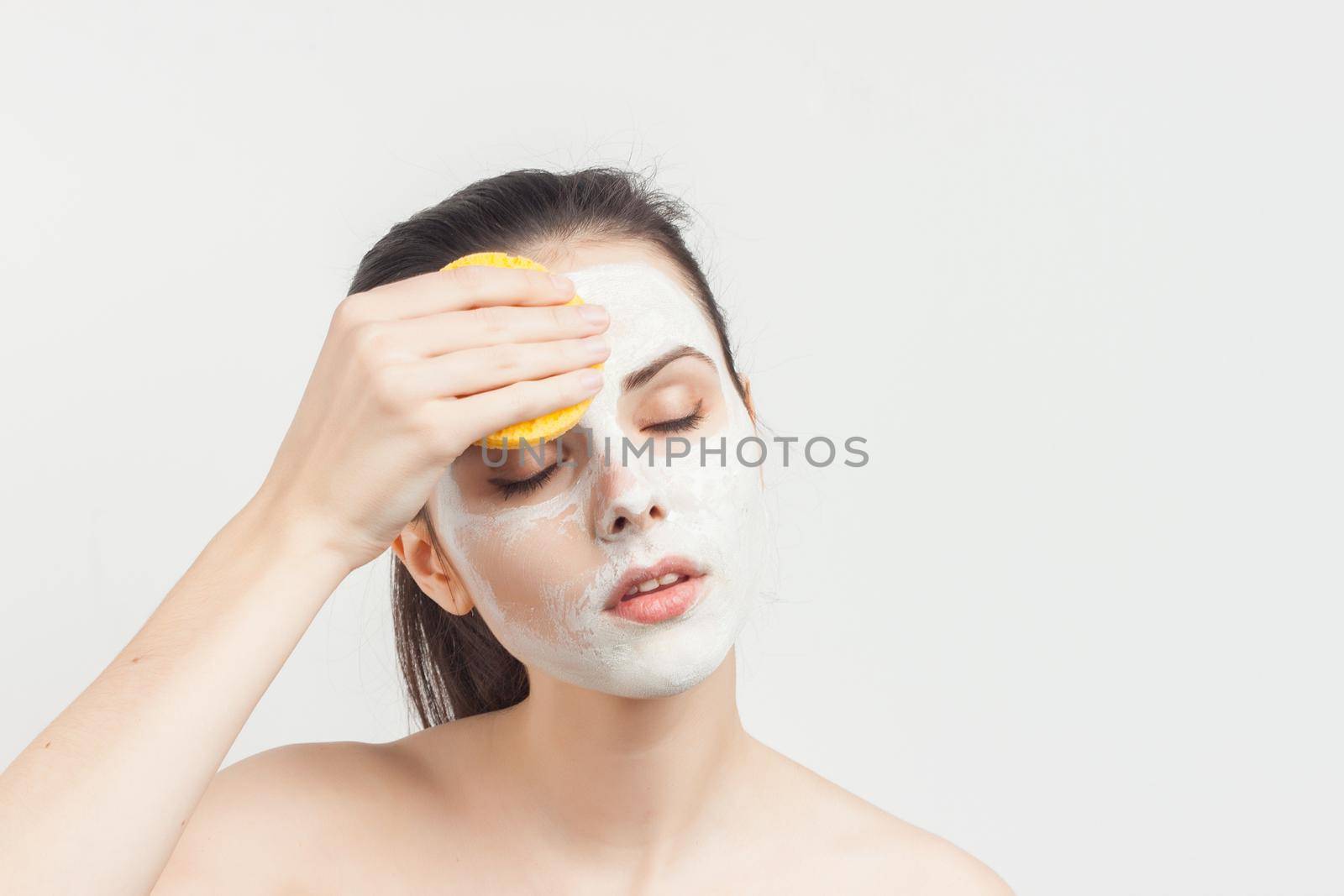 Pretty Brunette Nude Shoulders Facial Cream Spa Treatments. High quality photo