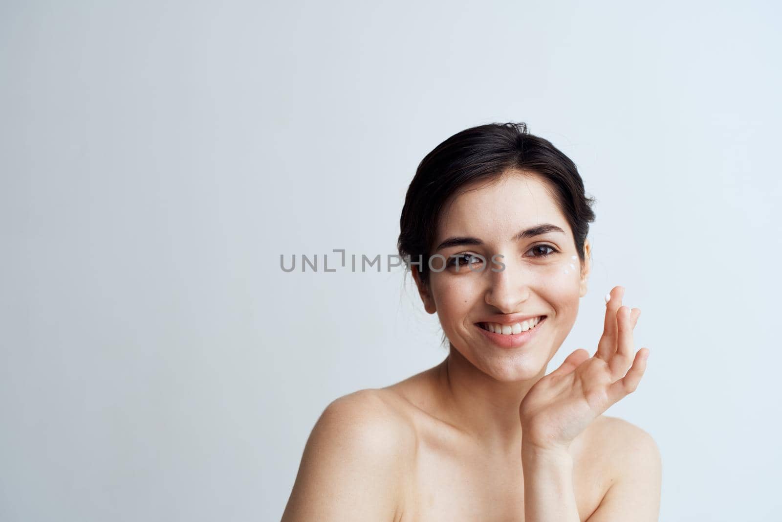 Beautiful brunette clean skin care face dermatology cream. High quality photo