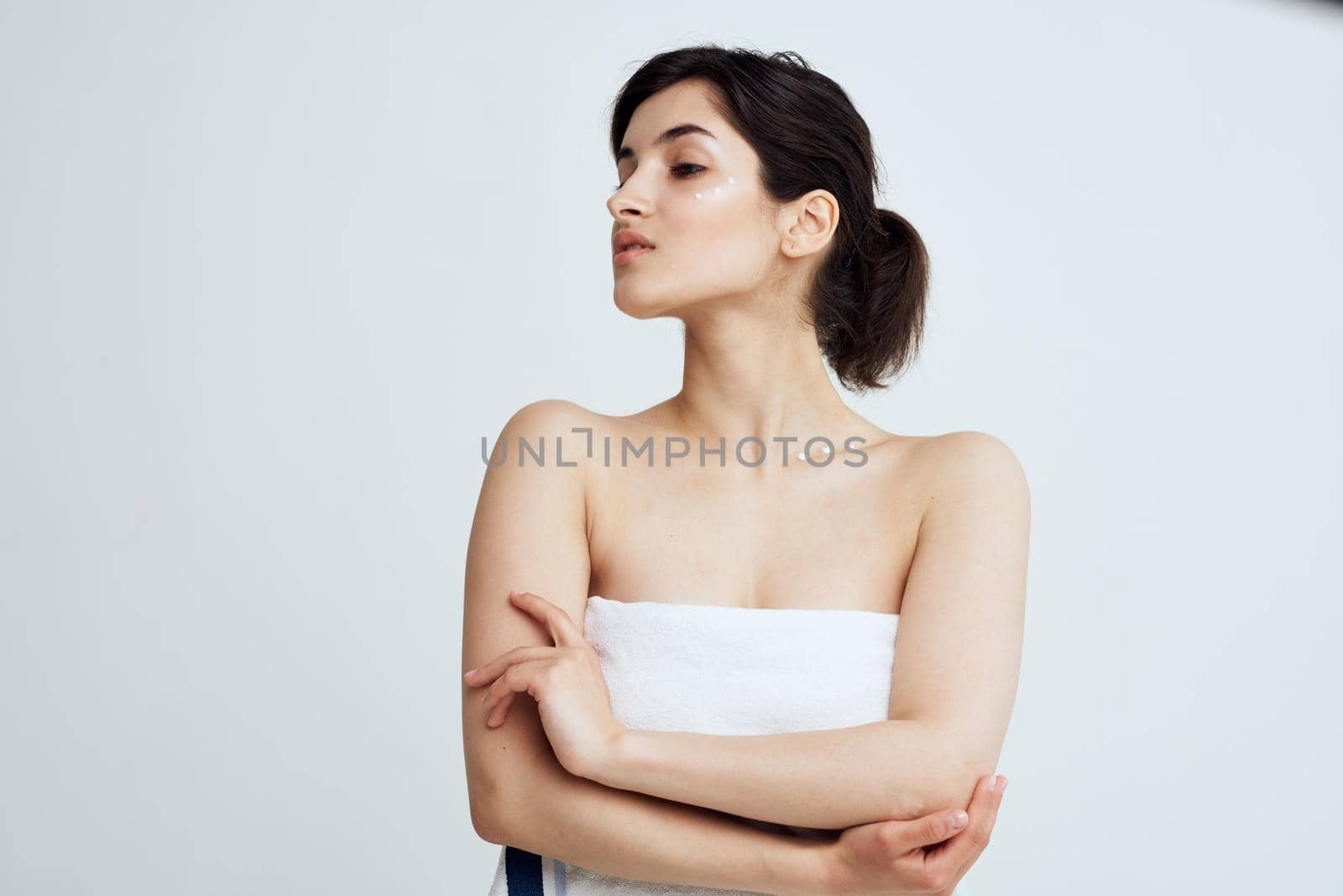 Pretty brunette bare shoulders white towel clean skin shower. High quality photo