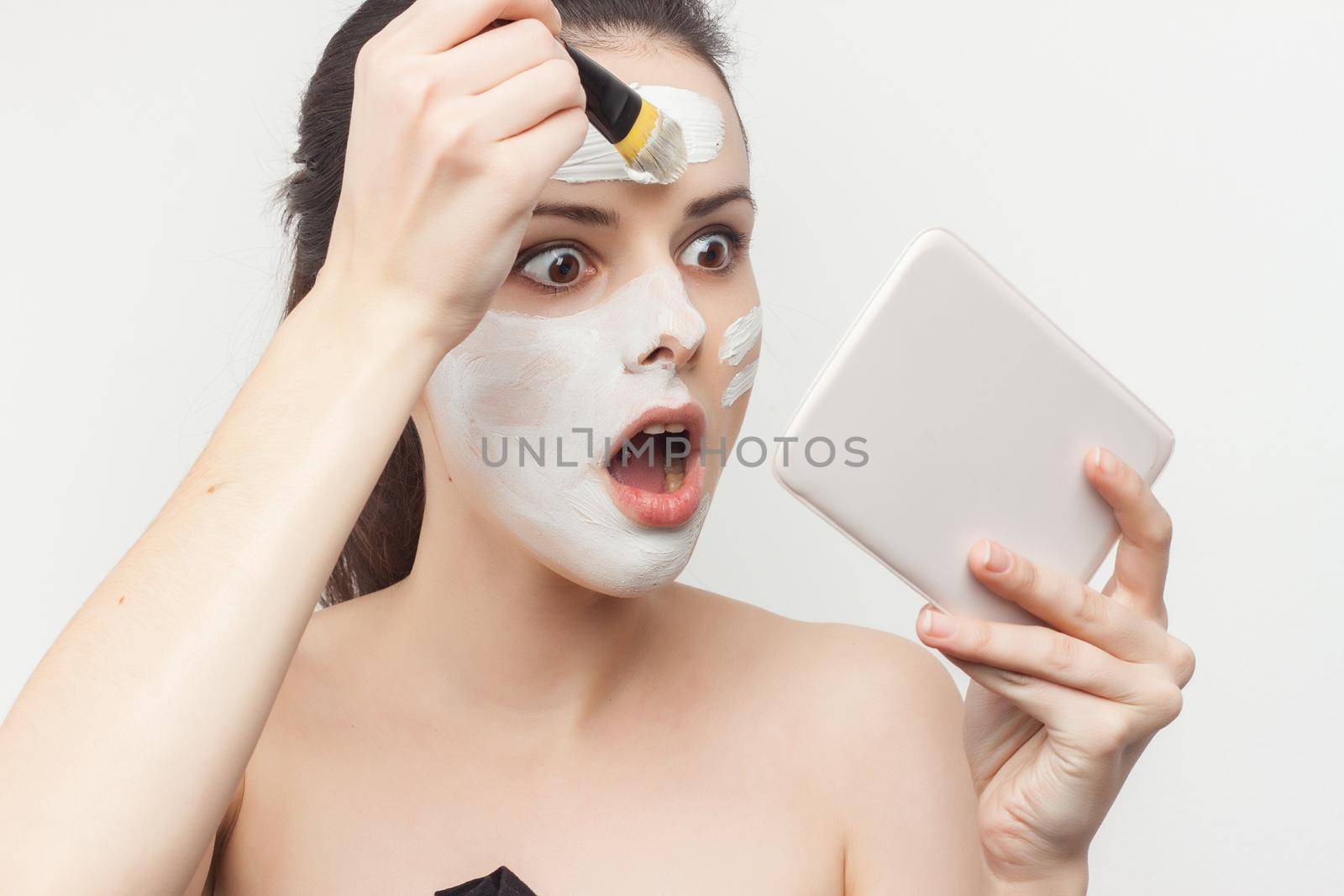Pretty Brunette Nude Shoulders Facial Cream Spa Treatments. High quality photo