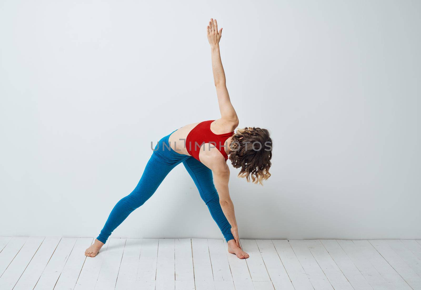 Woman spread her legs bent forward sport fitness gymnastics yoga by SHOTPRIME