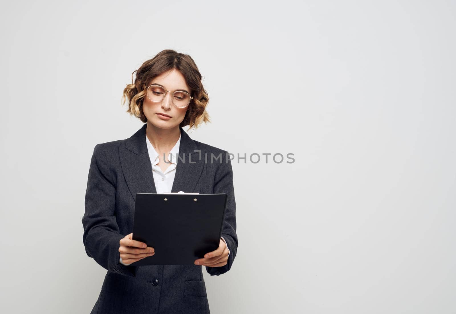 Woman with a folder of documents in her hands on a light background Copy Space. High quality photo